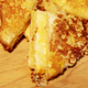 French toast grilled cheese on a cutting board, sliced into four triangles